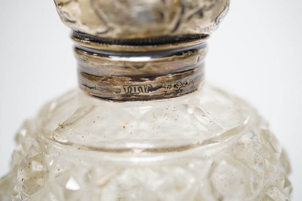 Four assorted mounted glass scent bottles, including three with silver mounts, tallest 11.9cm. Condition - poor